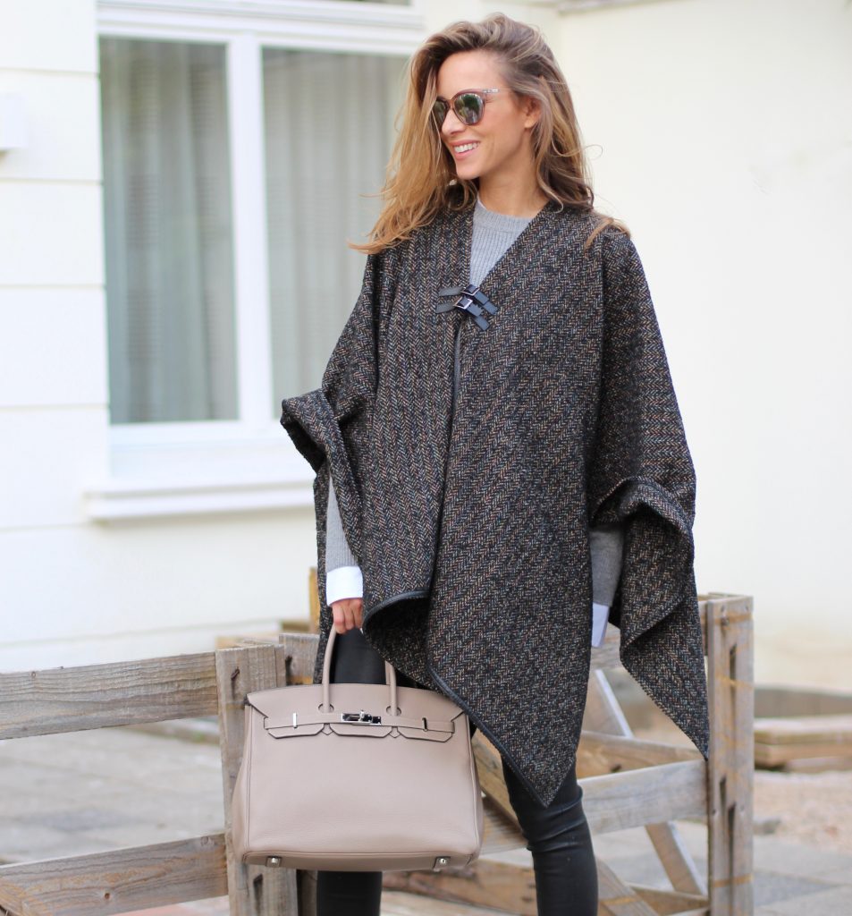 Alexandra Lapp wearing shades of grey, SET leather pants, Steffen Schraut cape and knitwear, Celine oversize shirt, Ash boots, Le Specs sunglasses and Hermès Birkin bag.