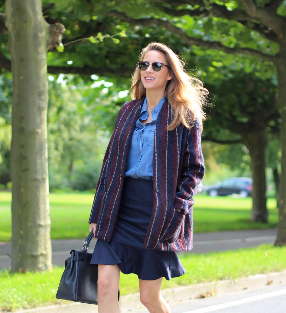 Alexandra Lapp wearing College Set, collage jacket and skirt by SET, Asos denim blouse, Hermès Kelly bag, Ray Ban sunglasses and Gianvito Rossi ankle boots. 