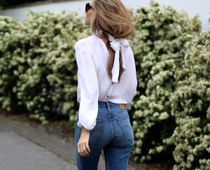 Alexandra Lapp wearing a tie neck blouse from Emilio Pucci, Levi's, Miu Miu, Céline, Hermès