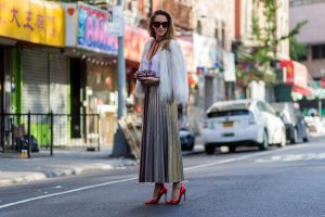 Alexandra Lapp wearing a metallic skirt by Max & Co., silk top by Jadicted, faux fur jacket by Steffen Schraut, pumps by Gianvito Rossi, clutch by Alexander McQueen, sunglasses by Céline in New York during NYFW.