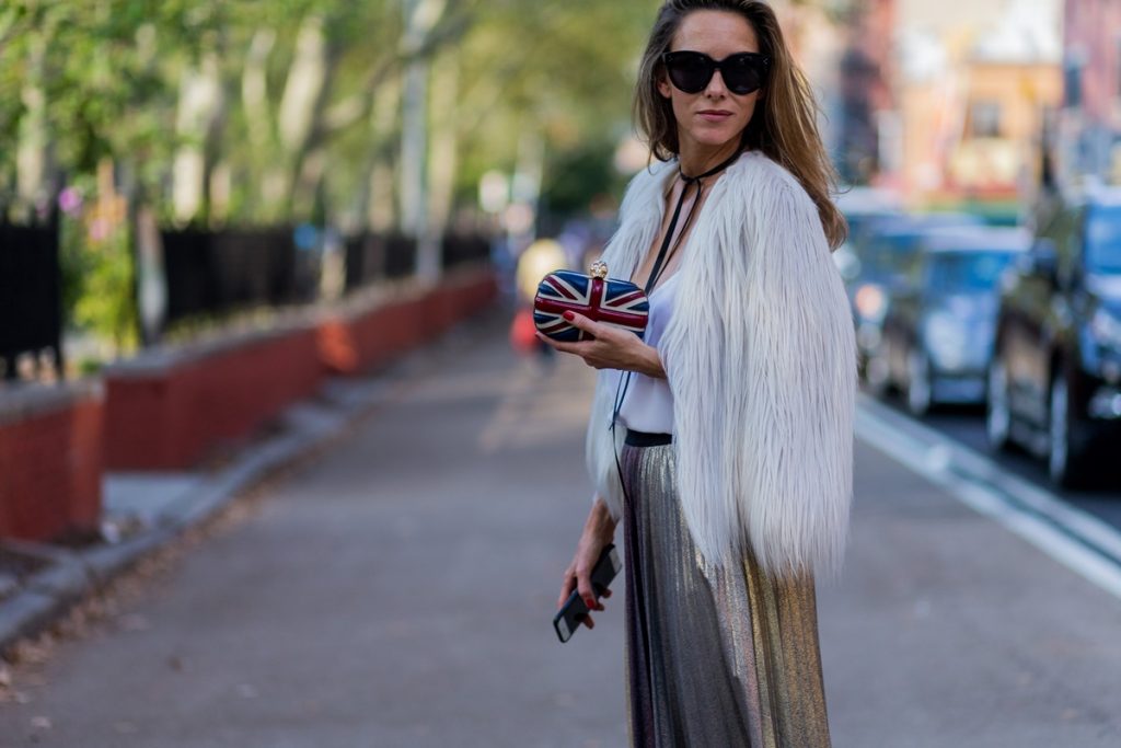Alexandra Lapp wearing a metallic skirt by Max & Co., silk top by Jadicted, faux fur jacket by Steffen Schraut, pumps by Gianvito Rossi, clutch by Alexander McQueen, sunglasses by Céline in New York during NYFW.