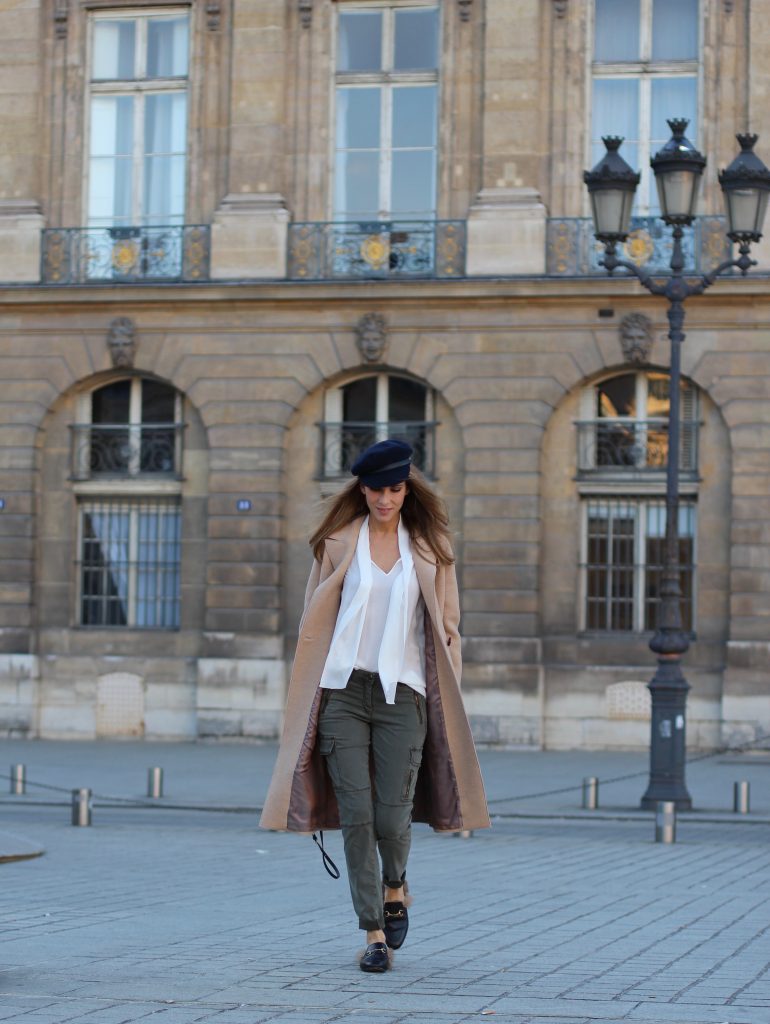 Place Vendôme, PARIS, FRANCE - NOVEMBER : German model and fashion blogger Alexandra Lapp (@alexandralapp_) wearing a camel coat, tie neck blouse and pants by Marc Aurel, princetown slippers from Gucci and peekaboo mini bag from Fendi, on November 2016 in Paris, France. *** Local Caption *** Alexandra Lapp