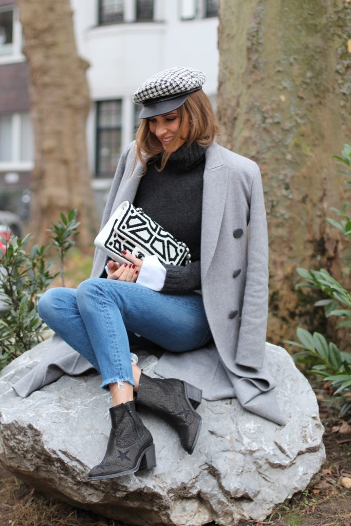 DÜSSELDORF; GERMANY - JANUARY : German model and fashion blogger Alexandra Lapp (@alexandralapp_) wearing western boots from Nubikk, high waist denim from Levi's, a white shirt and a grey cashmere coat by Céline, black and white bag from Chanel, hat from Eugenia Kim and cashmere knitwear by Loro Piana on January, 2017 in Germany*** Local Caption *** Alexandra Lapp
