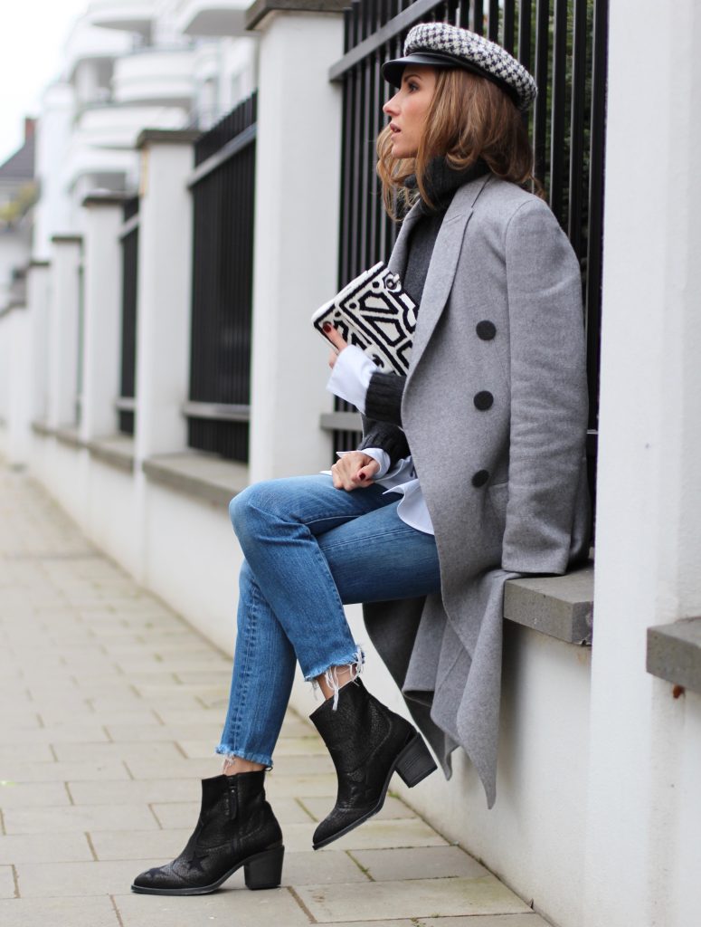 DÜSSELDORF; GERMANY - JANUARY : German model and fashion blogger Alexandra Lapp (@alexandralapp_) wearing western boots from Nubikk, high waist denim from Levi's, a white shirt and a grey cashmere coat by Céline, black and white bag from Chanel, hat from Eugenia Kim and cashmere knitwear by Loro Piana on January, 2017 in Germany*** Local Caption *** Alexandra Lapp