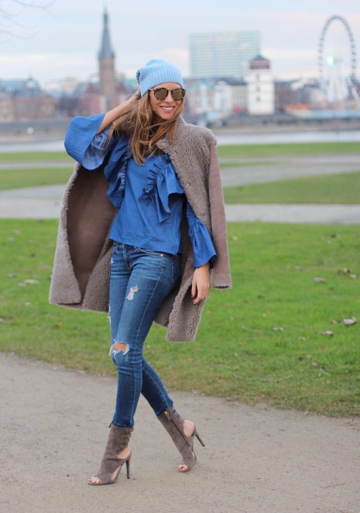 DÜSSELDORF; GERMANY - DEZEMBER : German model and fashion blogger Alexandra Lapp (@alexandralapp_) wearing denim on denim, a denim blouse from Storets, denim by Adriano Goldschmied, velvet booties by Halston, a baby blue beanie from Marc Cain, sunglasses by Le Specs, coat and bag by Steffen Schraut on Dezember, 2016 in Germany*** Local Caption *** Alexandra Lapp