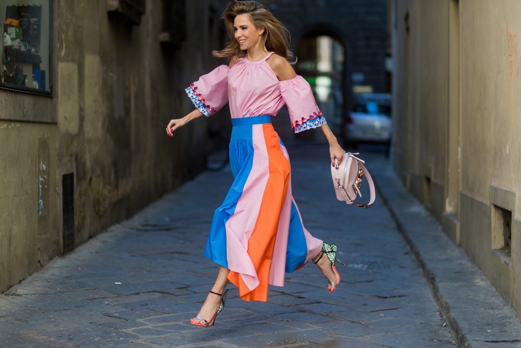 FLORENCE, ITALY - JANUARY 11: German fashion blogger and model Alexandra Lapp is wearing off-the-shoulder embroidered cotton-poplin blouse by Peter Pilotto, asymmetric cotton-poplin skirt by Peter Pilotto (this skirt is made from panels of bright-blue, baby-pink and bright-orange cotton-poplin and is cut with an asymmetric midi hem), Fendi baby pink leather shoulder bag embellished with colorful pyramid studs and adjustable shoulder strap, ‘Chiara’ Butterfly style sandals from Sophia Webster ( printed Butterfly Wing sandal, finished with a silver mirror front strap) on January 11, 2017 in Florence, Italy. (Photo by Christian Vierig/Getty Images) *** Local Caption *** Alexandra Lapp