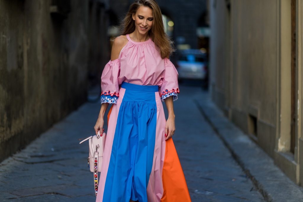 FLORENCE, ITALY - JANUARY 11: German fashion blogger and model Alexandra Lapp is wearing off-the-shoulder embroidered cotton-poplin blouse by Peter Pilotto, asymmetric cotton-poplin skirt by Peter Pilotto (this skirt is made from panels of bright-blue, baby-pink and bright-orange cotton-poplin and is cut with an asymmetric midi hem), Fendi baby pink leather shoulder bag embellished with colorful pyramid studs and adjustable shoulder strap, ‘Chiara’ Butterfly style sandals from Sophia Webster ( printed Butterfly Wing sandal, finished with a silver mirror front strap) on January 11, 2017 in Florence, Italy. (Photo by Christian Vierig/Getty Images) *** Local Caption *** Alexandra Lapp