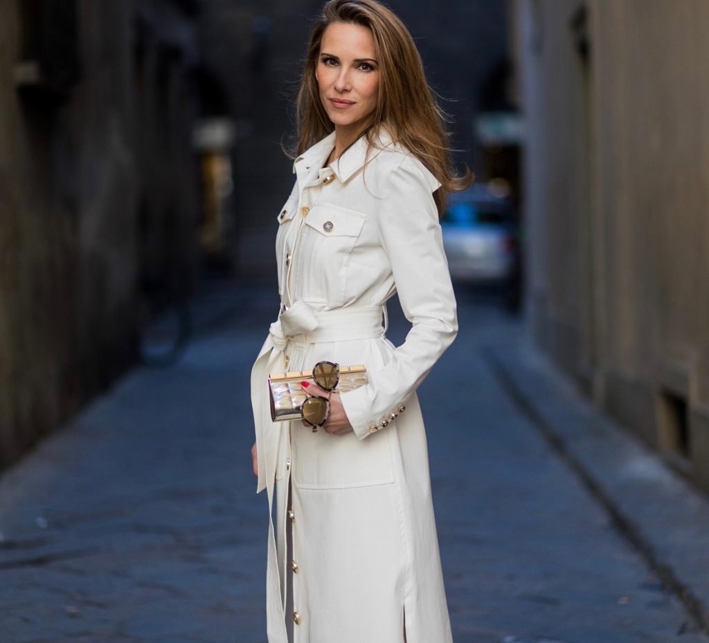 FLORENCE, ITALY - JANUARY 11: German fashion blogger and model Alexandra Lapp is wearing trenchcoat dress in white with golden buttons waisted with a belt from Talbot Runhof, Chanel mules and Chanel box clutch bag in gold (as seen on Carrie Bradshaw (Sarah Jessica Parker) in Sex and the City 2, sunglasses from Les Specs on January 11, 2017 in Florence, Italy. (Photo by Christian Vierig/Getty Images) *** Local Caption *** Alexandra Lapp