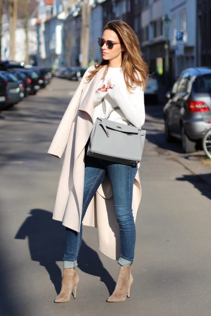 DÜSSELDORF, GERMANY - FEBRUARY 14: German fashion blogger and model Alexandra Lapp is wearing double denim - a light blue denim jacket by SET, slim fit high waist denim from Rag and Bone, off white knitwear from Oui, Hermes Kelly bag in light grey, Le Specs sunglasses, beige velvet booties from Gianvito Rossi and a light beige wool coat from Steffen Schraut on February 14, 2017 Düsseldorf, Germany. *** Local Caption *** Alexandra Lapp