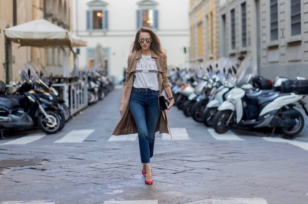 FLORENCE, ITALY - JANUARY 11: German fashion blogger and model Alexandra Lapp is wearing retro vibe Gucci printed cotton T-shirt, featuring a throwback Gucci logo, this piece features distressed detailing around the neckline, slim fit Wedgie Icon Fit Jeans from Levi’s, suede /buckskin leather trench coat from Oui, Dionysus GG Supreme Medium Gucci shoulder bag, Le Specs sunglasses, red pumps from Gianvito Rossi on January 11, 2017 in Florence, Italy. (Photo by Christian Vierig/Getty Images) *** Local Caption *** Alexandra Lapp