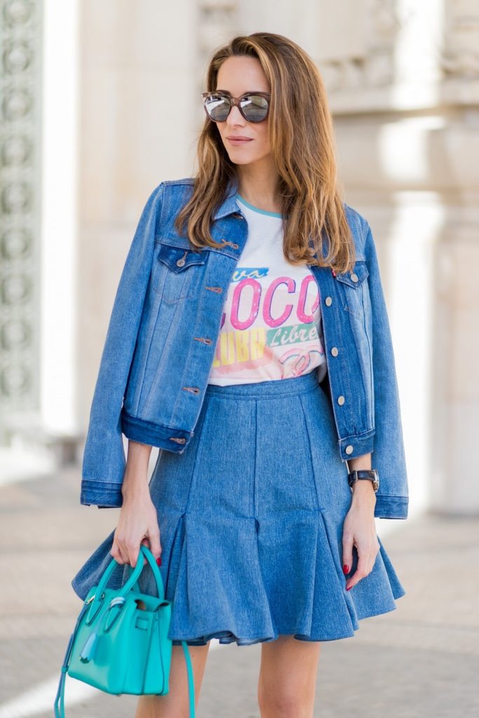 PARIS; FRANCE; during PFW, Blogger and Model Alexandra Lapp wearing a Statement shirt, a colorful graphic T-Shirt from Chanel Cuba Cruise 2017 collection, A-line denim skirt from Balmain, trucker denim Jacket from Levis, two tone pumps in oasis green with a silver toe cap in 10cm from Manolo Blahnik, Bag MCM Milla bag, Sunglasses by Les Specs on March 3, 2017 in Paris, France.