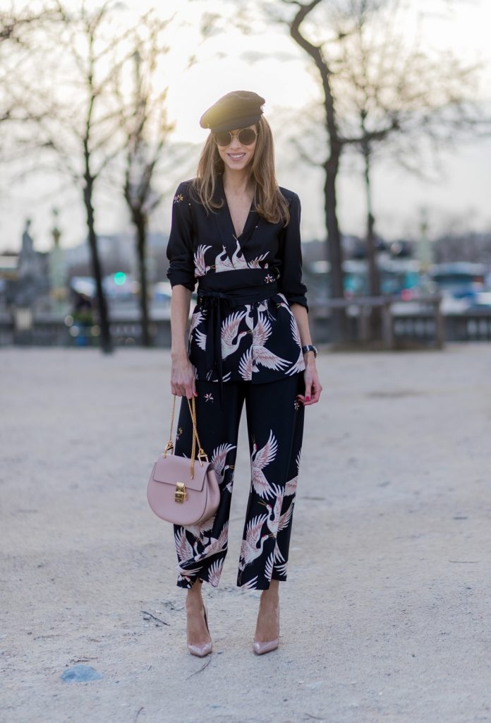 PARIS; FRANCE; during PFW, Model and Blogger Alexandra Lapp wearing Sleepwear to Daywear, Printed jacket with contrasting sash belt, lapel collar and long sleeves from Zara in black with rose birds, Matching flowing printed culottes from Zara in black with rose birds, Christian Louboutin nude lacquer pumps, nude Drew small leather cross-body bag by Chloe, Cap from Chanel, Sunglasses by Chloe on March 3, 2017 in Paris, France.