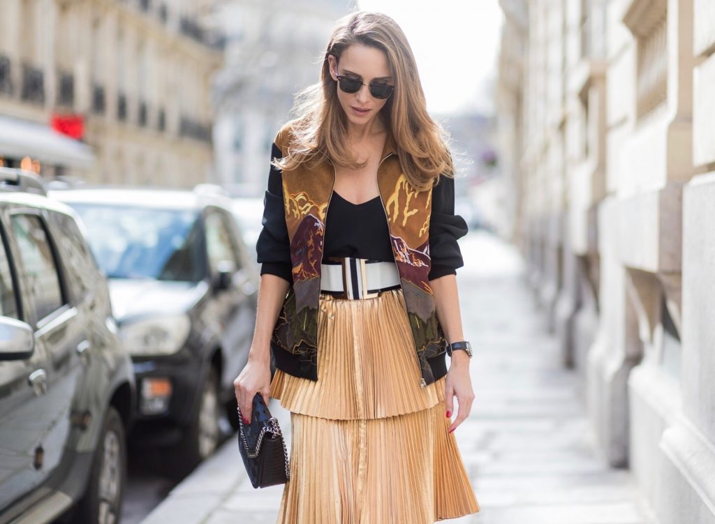 PARIS;FRANCE during PFW, Model and Blogger Alexandra Lapp wearing a pleated skirt & bomber jacket from Stella McCartney, skirt named Melody skirt, Stella McCartney blue Falabella box mini shoulder bag, black silk Tank top from Jadicted, white lacquer pumps by Prada, RayBan clubmaster sunglasses, waist belt in black and white by Balmain on March 3, 2017 in Paris, France.