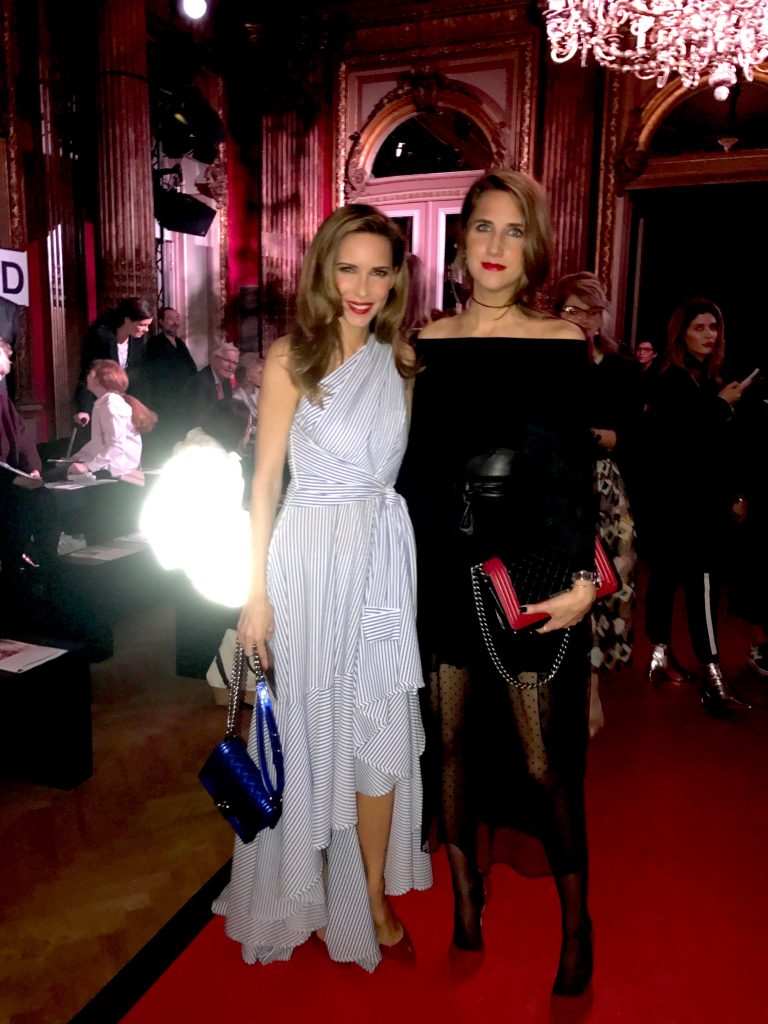 PARIS; FRANCE; Model and Blogger Alexandra Lapp and her sister Isabel Lapp during Talbot Runhof Show in Paris, is wearing a striped shirt dress, a long dress made of stripe stretch seersucker in greek blue and white from Talbot Runhof, blue plexi pumps from Gianvito Rossi and a blue Boy bag from Chanel on March 4, 2017 in Paris, France.