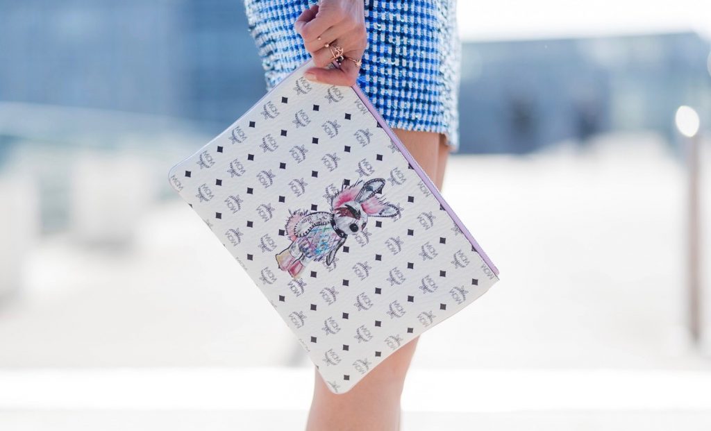 Happy Easter; Model and fashion blogger Alexandra Lapp wearing a sequin skirt by Ashish, stole / shawl and pullover made of cashmere from Heartbreaker, black sunglasses from Celine, neon pink So Kate' pumps by Christian Louboutin and a clutch bag in white with MCM monogram in black, detailed with a drawing of a funky punk rabbit on March 30, 2017 in Duesseldorf, Germany.