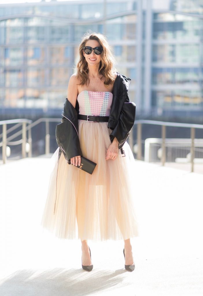 Model and fashion blogger Alexandra Lapp wearing a Carrie Bradshaw style, a multicolored sleeveless brocade tulle dress from Natasha Zinko, a black biker leather jacket with sewed on flowers with pearl applications from Natasha Zinko, black suede So Kate pums from Christian Louboutin, and black sunglasses from Celine on March 30, 2017 in Duesseldorf, Germany.