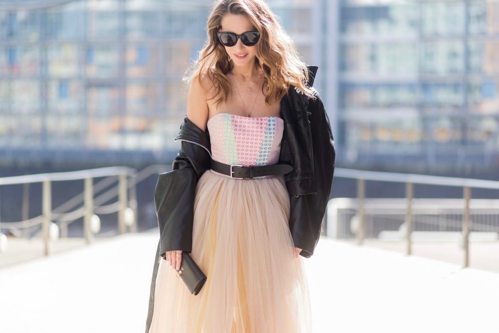 Model and fashion blogger Alexandra Lapp wearing a Carrie Bradshaw style, a multicolored sleeveless brocade tulle dress from Natasha Zinko, a black biker leather jacket with sewed on flowers with pearl applications from Natasha Zinko, black suede So Kate pums from Christian Louboutin, and black sunglasses from Celine on March 30, 2017 in Duesseldorf, Germany.