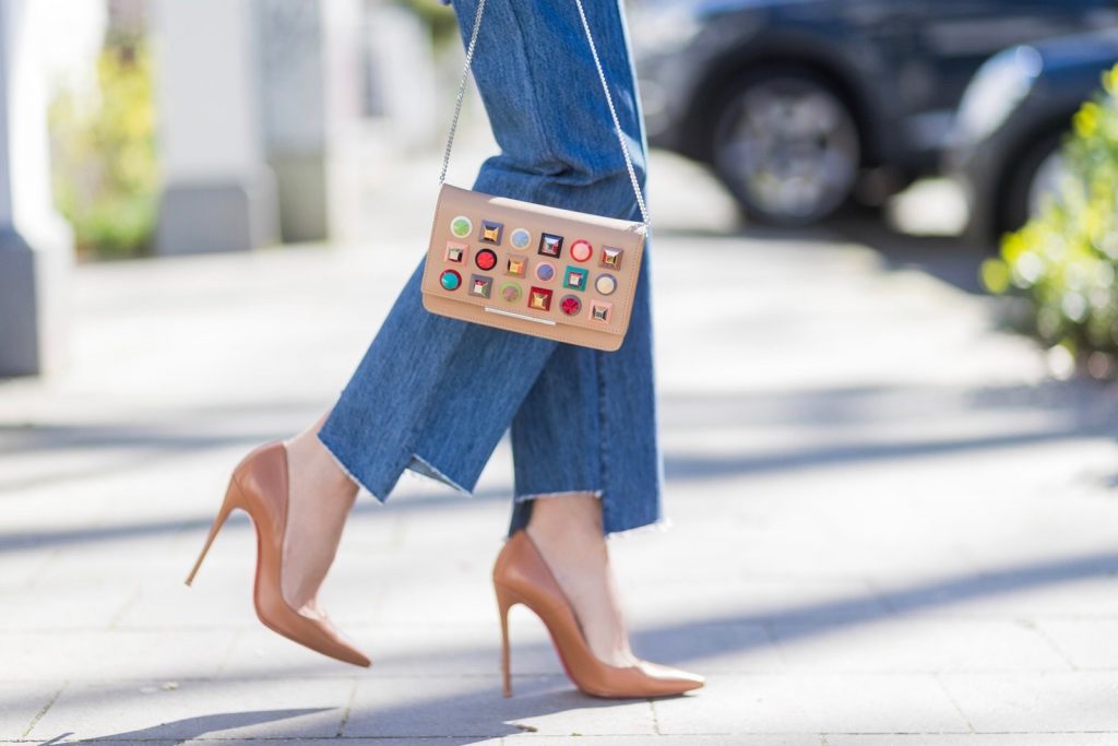 Model and fashion blogger Alexandra Lapp wearing an oversized navy and white striped cotton shirt, cut for an oversized fit with a point collar and dropped shoulders from Vetements, blue jeans from Vetements in cooperation with Levi`s with cut-out raw hems, blue aviator sunglasses from illevesta, Christian Louboutin pumps in cognac, filigree rose gold jewelry from Art Youth Society and a studded embellished crossbody bag from Fendi featuring a foldover top with magnetic closure, an interior zipped compartment, multiple interior card slots and a silver-tone chain shoulder strap on March 30, 2017 in Duesseldorf, Germany.