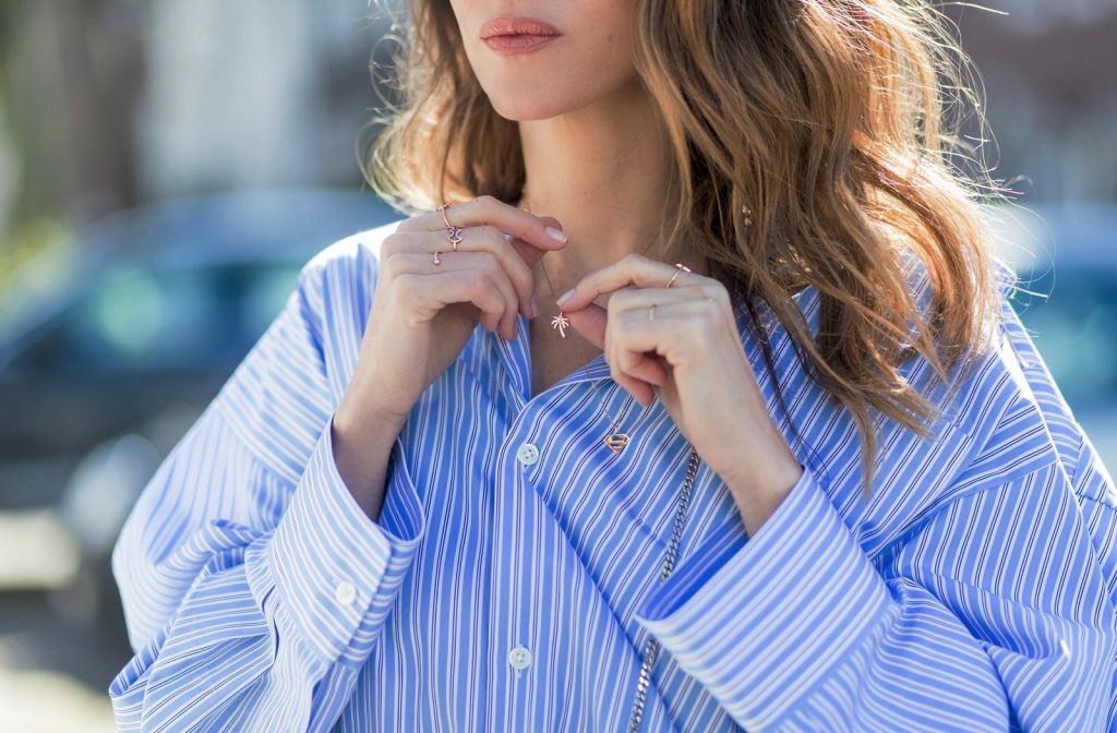 Model and fashion blogger Alexandra Lapp wearing an oversized navy and white striped cotton shirt, cut for an oversized fit with a point collar and dropped shoulders from Vetements, blue jeans from Vetements in cooperation with Levi`s with cut-out raw hems, blue aviator sunglasses from illevesta, Christian Louboutin pumps in cognac, filigree rose gold jewelry from Art Youth Society and a studded embellished crossbody bag from Fendi featuring a foldover top with magnetic closure, an interior zipped compartment, multiple interior card slots and a silver-tone chain shoulder strap on March 30, 2017 in Duesseldorf, Germany.