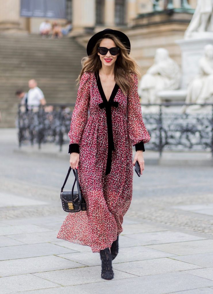 Alexandra Lapp wearing Boho Style, a red and cream floral print maxi dress from Philosophy di Lorenzo Serafini in sheer silk chiffon and bold black trims with a ribbon tie, Toubootfrou ankle boots with rete, organze and suede in black from Christian Louboutin, Celine Audrey sunglasses in black, Maison Maison Michel hat Virginie fedora, MCM Patricia Shoulder Bag in a vintage shape during the Mercedes-Benz Fashion Week Berlin Spring/Summer 2018 on July 7, 2017 in Berlin, Germany. Alexandra Lapp wearing Boho Style, a red and cream floral print maxi dress from Philosophy di Lorenzo Serafini in sheer silk chiffon and bold black trims with a ribbon tie, Toubootfrou ankle boots with rete, organze and suede in black from Christian Louboutin, Celine Audrey sunglasses in black, Maison Maison Michel hat Virginie fedora, MCM Patricia Shoulder Bag in a vintage shape during the Mercedes-Benz Fashion Week Berlin Spring/Summer 2018 on July 7, 2017 in Berlin, Germany.