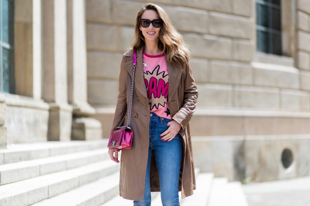 Alexandra Lapp wearing a leather coat in cognac by Riani, a round neck pullover, printed with BAM in comic style and pailettes, Levis Wedgie Icon Fit jeans in slim fit and dark blue, a Boy bag in metallic pink patent leather, Gucci sunglasses and cognac So Kate high heels from Christian Louboutin during the Mercedes-Benz Fashion Week Berlin Spring/Summer 2018 on July 7, 2017 in Berlin, Germany.