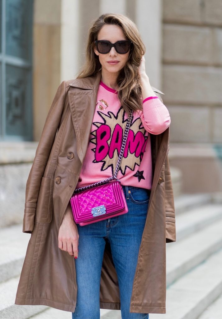 Alexandra Lapp wearing a leather coat in cognac by Riani, a round neck pullover, printed with BAM in comic style and pailettes, Levis Wedgie Icon Fit jeans in slim fit and dark blue, a Boy bag in metallic pink patent leather, Gucci sunglasses and cognac So Kate high heels from Christian Louboutin during the Mercedes-Benz Fashion Week Berlin Spring/Summer 2018 on July 7, 2017 in Berlin, Germany.