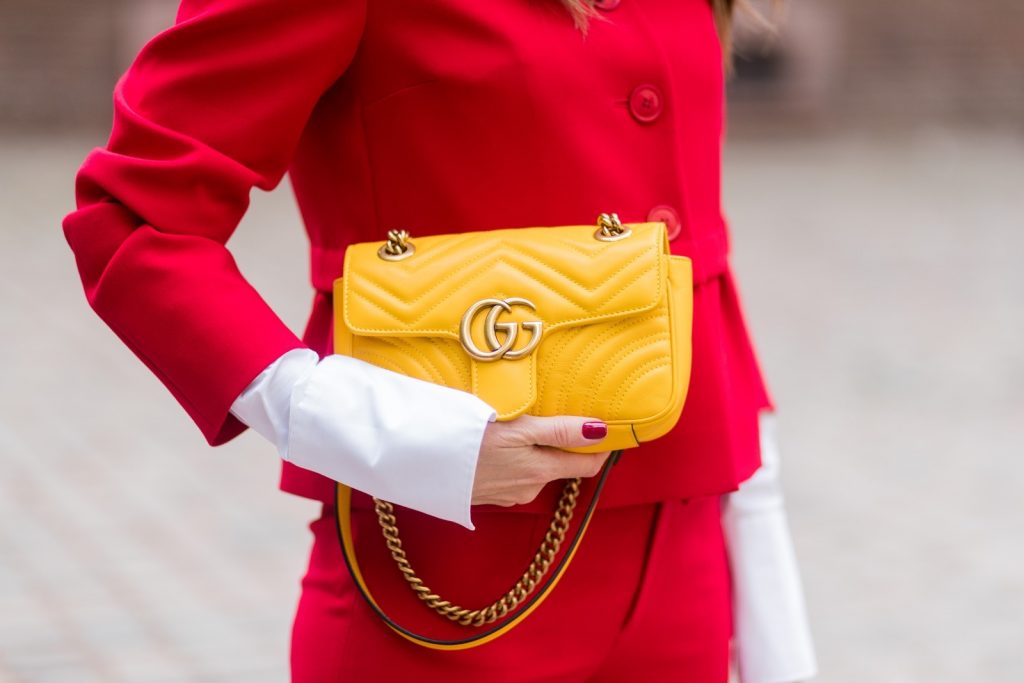 Model and fashion blogger Alexandra Lapp wearing a slim fit, red suit from Steffen Schraut, blazer with peplum and red pants, white blouse with a black ribbon bow from Steffen Schraut, white pumps with black toecap from Saint Laurent, Chanel sunglasses with pearls and yellow GG Marmont bag from Gucci on August 5, 2017 in Duesseldorf, Germany.