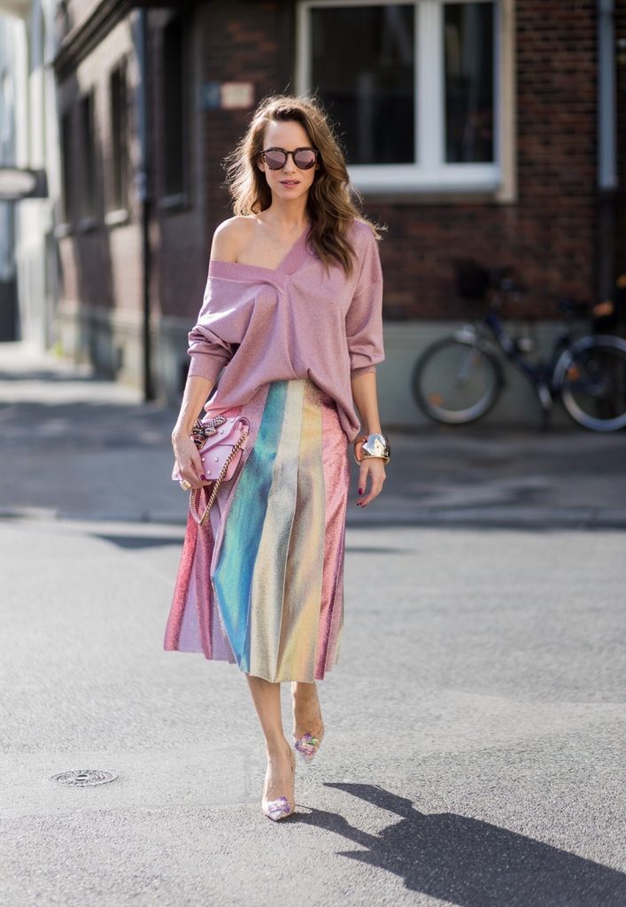 Model and fashion blogger Alexandra Lapp wearing metallic chic, pleated lame skirt in shimmering pastel, pink metallic v-neck knit by Alberta Ferretti, Christian Louboutin Feerica heels with Swarovski crystals and flower accessory, pink Broadway leather bag with pearl studs, Le Specs sunglasses, bracelet and rose gold ring with baguette diamonds by Schubart on August 4, 2017 in Duesseldorf, Germany.