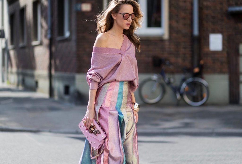 Model and fashion blogger Alexandra Lapp wearing metallic chic, pleated lame skirt in shimmering pastel, pink metallic v-neck knit by Alberta Ferretti, Christian Louboutin Feerica heels with Swarovski crystals and flower accessory, pink Broadway leather bag with pearl studs, Le Specs sunglasses, bracelet and rose gold ring with baguette diamonds by Schubart on August 4, 2017 in Duesseldorf, Germany.