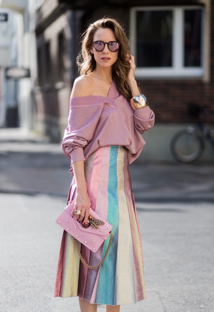 Model and fashion blogger Alexandra Lapp wearing metallic chic, pleated lame skirt in shimmering pastel, pink metallic v-neck knit by Alberta Ferretti, Christian Louboutin Feerica heels with Swarovski crystals and flower accessory, pink Broadway leather bag with pearl studs, Le Specs sunglasses, bracelet and rose gold ring with baguette diamonds by Schubart on August 4, 2017 in Duesseldorf, Germany.