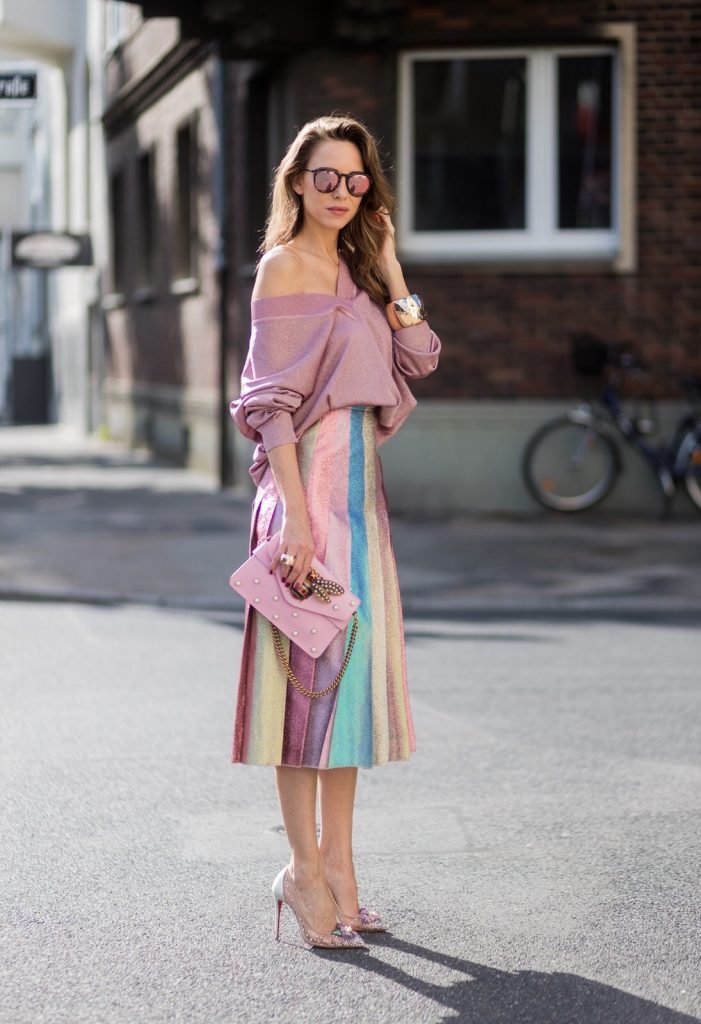 Model and fashion blogger Alexandra Lapp wearing metallic chic, pleated lame skirt in shimmering pastel, pink metallic v-neck knit by Alberta Ferretti, Christian Louboutin Feerica heels with Swarovski crystals and flower accessory, pink Broadway leather bag with pearl studs, Le Specs sunglasses, bracelet and rose gold ring with baguette diamonds by Schubart on August 4, 2017 in Duesseldorf, Germany.