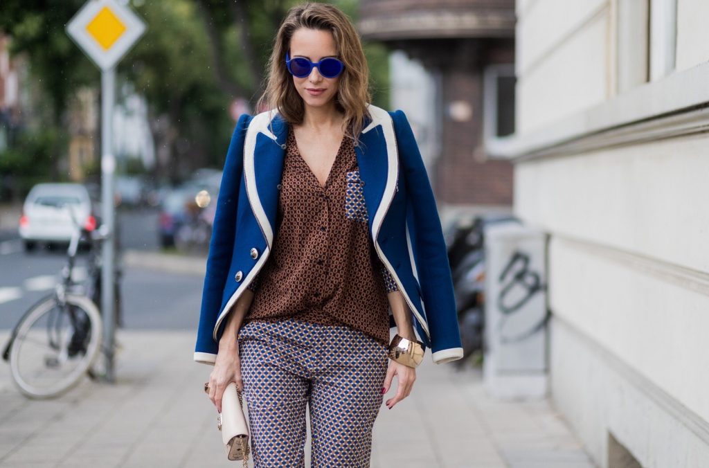 Model and fashion blogger Alexandra Lapp wearing pajama style, silk blouse and pants from Steffen Schraut, blue Balenciaga blazer jacket, blue lacquer pumps from Christian Louboutin, Millie cross body bag in beige from MCM with a golden chain, rose gold bracelet and rose gold ring with baguette diamonds from Schubart Goldschmiede on August 3, 2017 in Duesseldorf, Germany.
