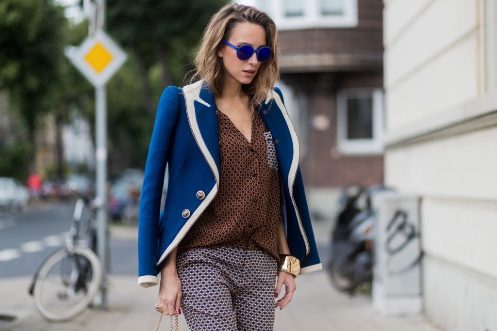 Model and fashion blogger Alexandra Lapp wearing pajama style, silk blouse and pants from Steffen Schraut, blue Balenciaga blazer jacket, blue lacquer pumps from Christian Louboutin, Millie cross body bag in beige from MCM with a golden chain, rose gold bracelet and rose gold ring with baguette diamonds from Schubart Goldschmiede on August 3, 2017 in Duesseldorf, Germany.