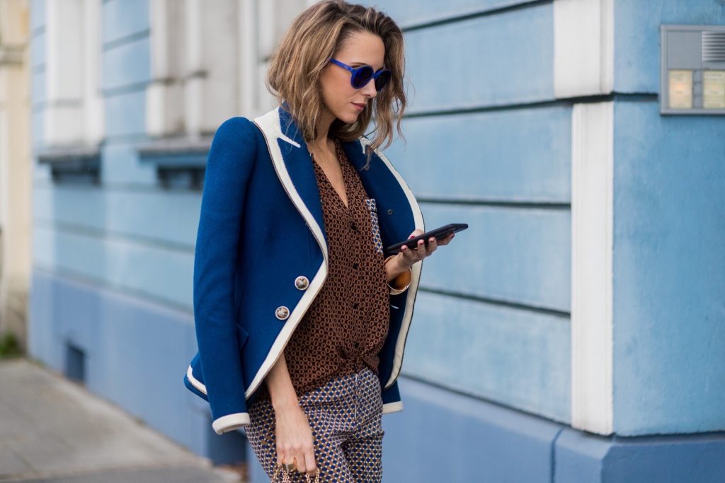 Model and fashion blogger Alexandra Lapp wearing pajama style, silk blouse and pants from Steffen Schraut, blue Balenciaga blazer jacket, blue lacquer pumps from Christian Louboutin, Millie cross body bag in beige from MCM with a golden chain, rose gold bracelet and rose gold ring with baguette diamonds from Schubart Goldschmiede on August 3, 2017 in Duesseldorf, Germany.