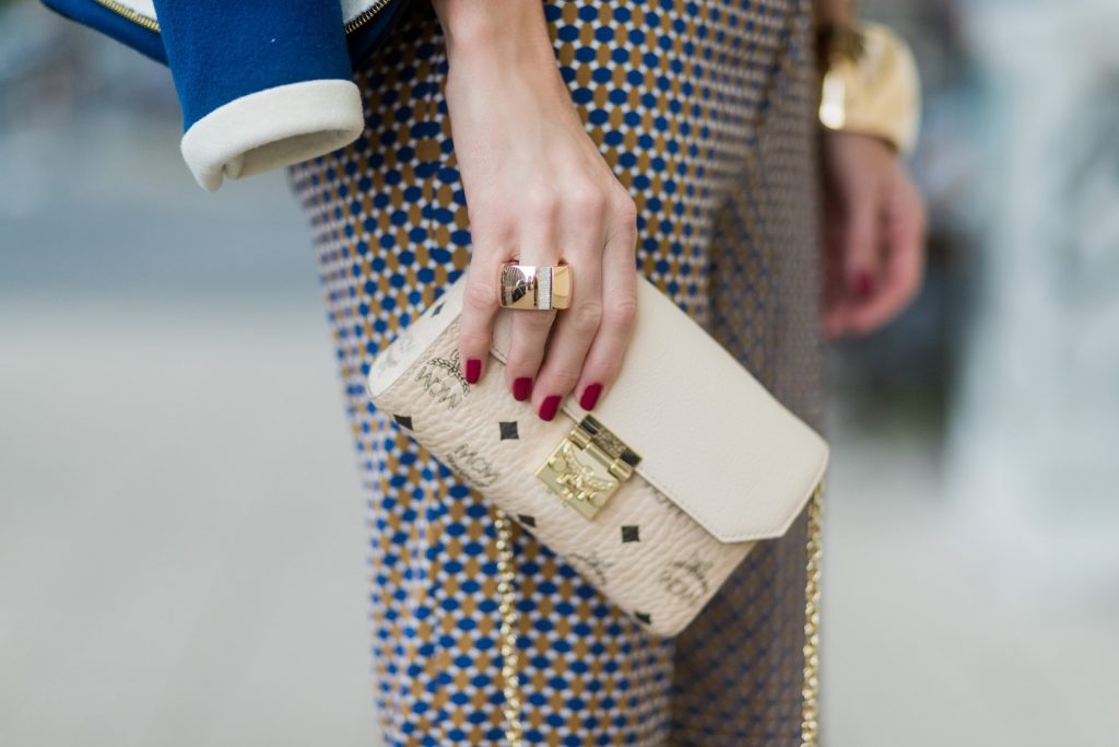Model and fashion blogger Alexandra Lapp wearing pajama style, silk blouse and pants from Steffen Schraut, blue Balenciaga blazer jacket, blue lacquer pumps from Christian Louboutin, Millie cross body bag in beige from MCM with a golden chain, rose gold bracelet and rose gold ring with baguette diamonds from Schubart Goldschmiede on August 3, 2017 in Duesseldorf, Germany.