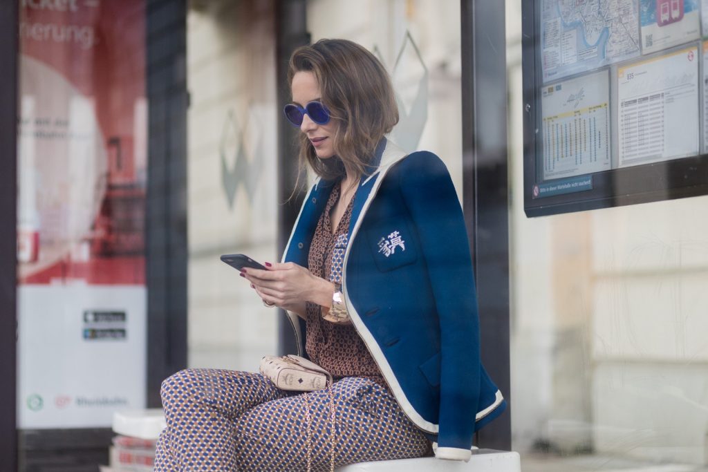 Model and fashion blogger Alexandra Lapp wearing pajama style, silk blouse and pants from Steffen Schraut, blue Balenciaga blazer jacket, blue lacquer pumps from Christian Louboutin, Millie cross body bag in beige from MCM with a golden chain, rose gold bracelet and rose gold ring with baguette diamonds from Schubart Goldschmiede on August 3, 2017 in Duesseldorf, Germany.