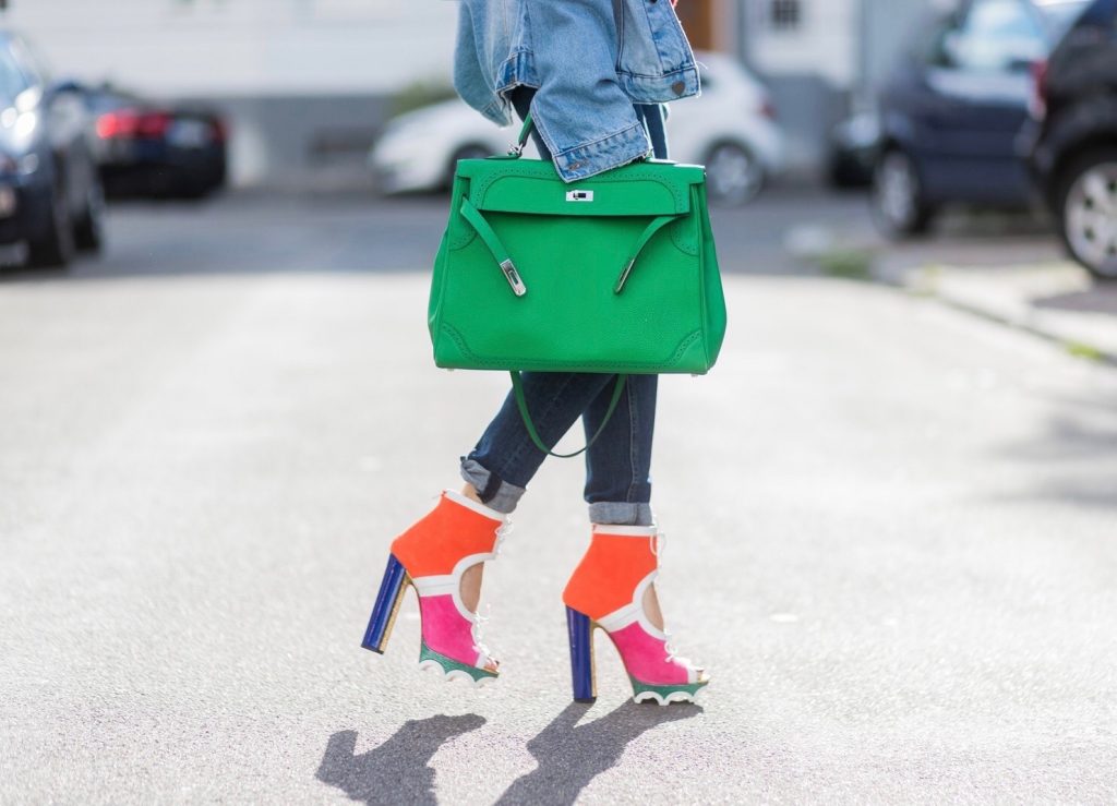 Model and fashion blogger Alexandra Lapp wearing color blocking, oversized denim jacket by SET, high waist denim from Rag and Bone Jeans, red cashmere hoodie with pink flowers by Heartbreaker, green Kelly bag by Hermes, Lolacramp color blocking heels from Christian Louboutin and Gucci sunglasses on August 5, 2017 in Duesseldorf, Germany.