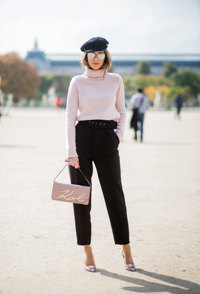 Alexandra Lapp wearing high waist pants in black from Zara, cashmere turtleneck in light pink from Jil Sander, light pink calf leather logo plaque shoulder bag from Karl Lagerfeld, Karl Lagerfeld bag, mirrored sunglasses by Le Specs, hat by Chanel, IWC Portugieser watch and Christian Louboutin Feerica heels with crystal embellished flower and glitter is seen during Paris Fashion Week Spring/Summer 2018 on September 29, 2017 in Paris, France.