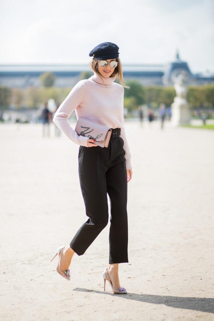 Alexandra Lapp wearing high waist pants in black from Zara, cashmere turtleneck in light pink from Jil Sander, light pink calf leather logo plaque shoulder bag from Karl Lagerfeld, Karl Lagerfeld bag, mirrored sunglasses by Le Specs, hat by Chanel, IWC Portugieser watch and Christian Louboutin Feerica heels with crystal embellished flower and glitter is seen during Paris Fashion Week Spring/Summer 2018 on September 29, 2017 in Paris, France.