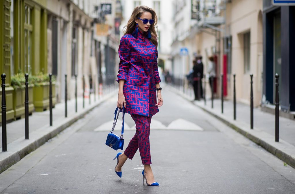 Alexandra Lapp wearing a two-piece suit in red and blue by Riani, a blue lacquer Chanel Boy bag, blue sunglasses by Etnia Barcelona, plexi pumps in blue from Gianvito Rossi and blue tassel earrings from Zara is seen during Paris Fashion Week Spring/Summer 2018 on September 26, 2017 in Paris, France.
