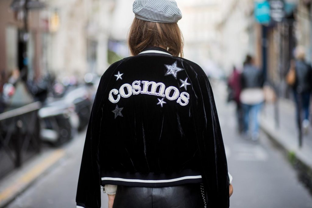 Alexandra Lapp wearing French Chic, an A-line leather rocky biker skirt from SET Fashion, striped knit jumper from Zara, plaid Zara hat, Isabel Marant slouchy boots, detailed with chain-trimmed ties to wrap around the leg, black Boy bag from Chanel and velvet bomber jacked with a Cosmo application is seen during Paris Fashion Week Spring/Summer 2018 on September 29, 2017 in Paris, France.