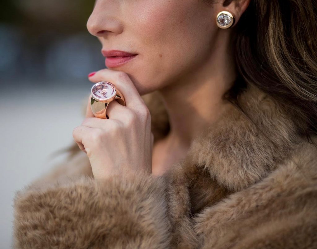 Alexandra Lapp wearing Morganite jewelry, rings and earrings by Schubart an oversized MCM Stark Pouch in Shearling Stripe, a lambskin coat in light brown by Yves Salomon, black and white big waist-belt from Balmain and striped Christian Louboutin 'So Kate' heels is seen during Paris Fashion Week Spring/Summer 2018 on September 28, 2017 in Paris, France.
