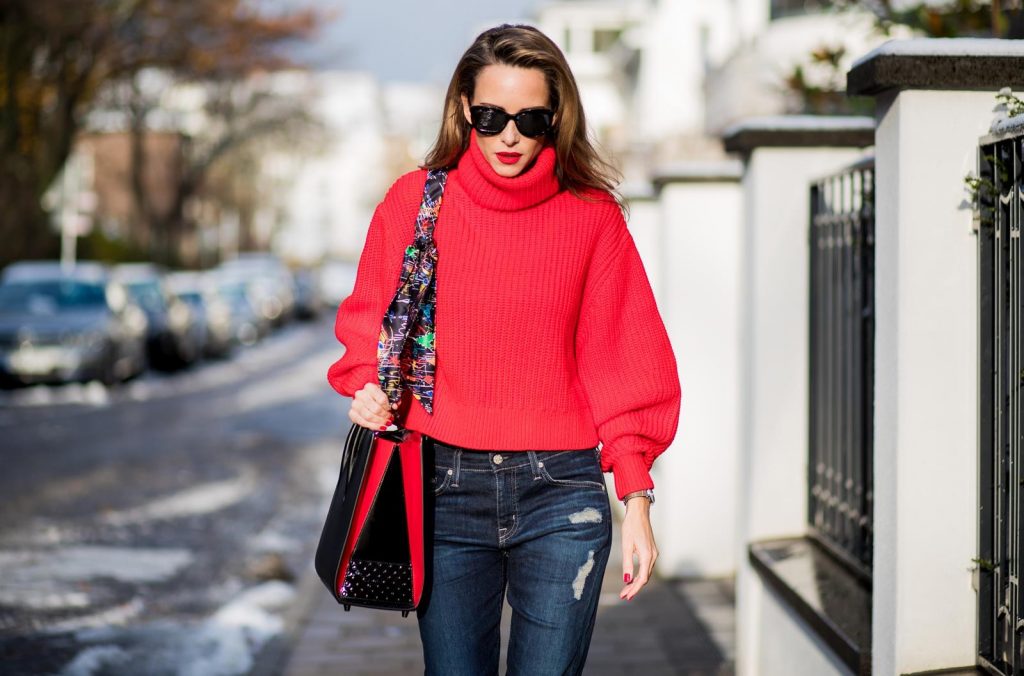 Alexandra Lapp wearing a cropped red turtleneck from H&M, Adriano Goldschmied Boyfriend denim from AG Jeans, Diormania sunglasses by Dior, Opyum 110 ankle boots in patent from Dior, Paloma medium handbag from Christian Louboutin, IWC watch on December 11, 2017 in Duesseldorf, Germany.