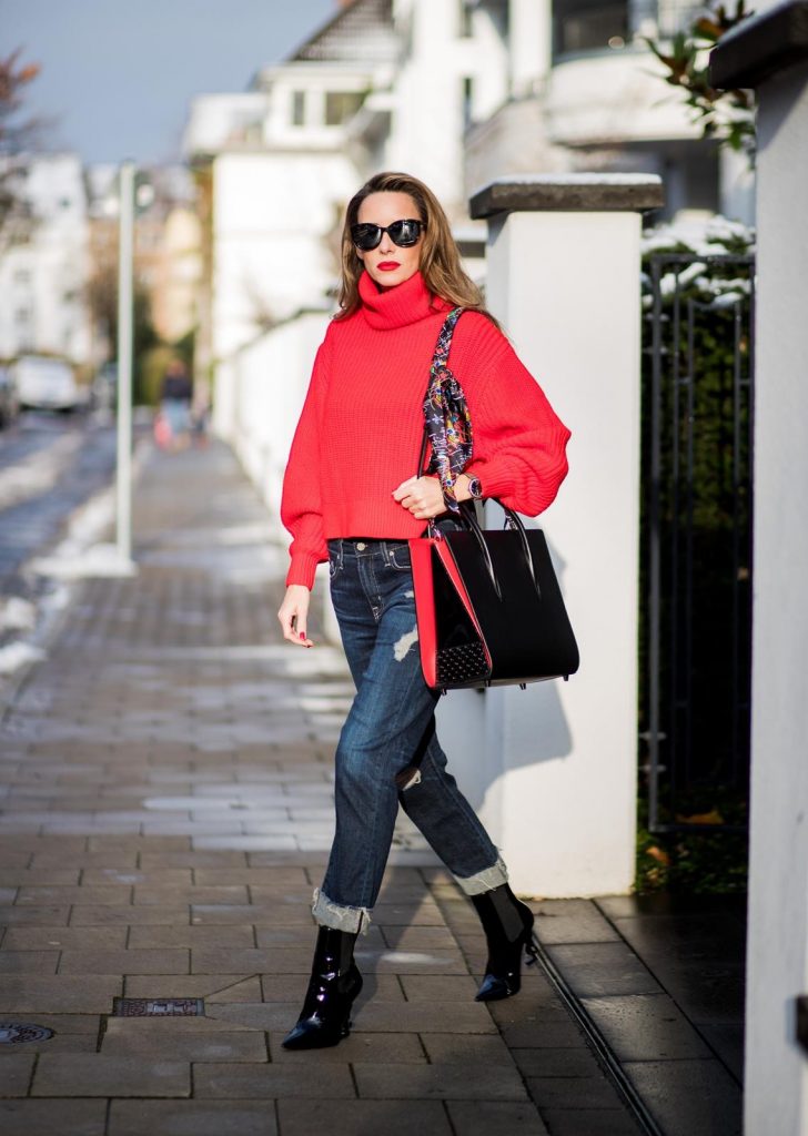 Alexandra Lapp wearing a cropped red turtleneck from H&M, Adriano Goldschmied Boyfriend denim from AG Jeans, Diormania sunglasses by Dior, Opyum 110 ankle boots in patent from Dior, Paloma medium handbag from Christian Louboutin, IWC watch on December 11, 2017 in Duesseldorf, Germany.