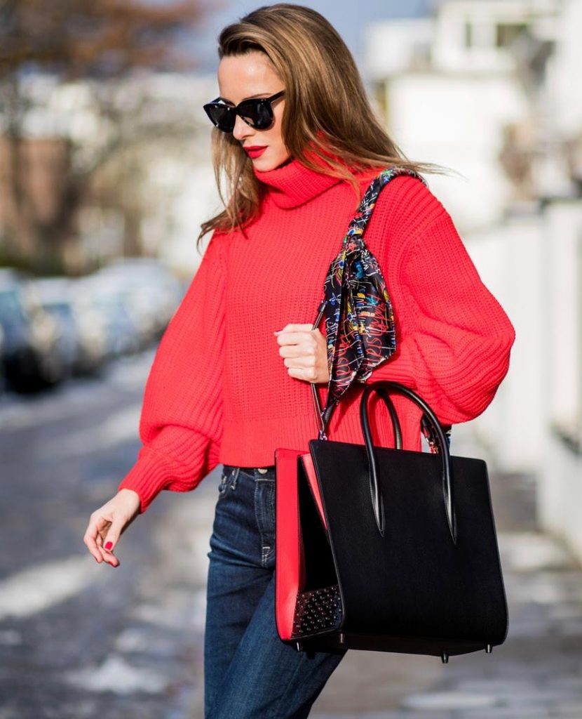 Alexandra Lapp wearing a cropped red turtleneck from H&M, Adriano Goldschmied Boyfriend denim from AG Jeans, Diormania sunglasses by Dior, Opyum 110 ankle boots in patent from Dior, Paloma medium handbag from Christian Louboutin, IWC watch on December 11, 2017 in Duesseldorf, Germany.