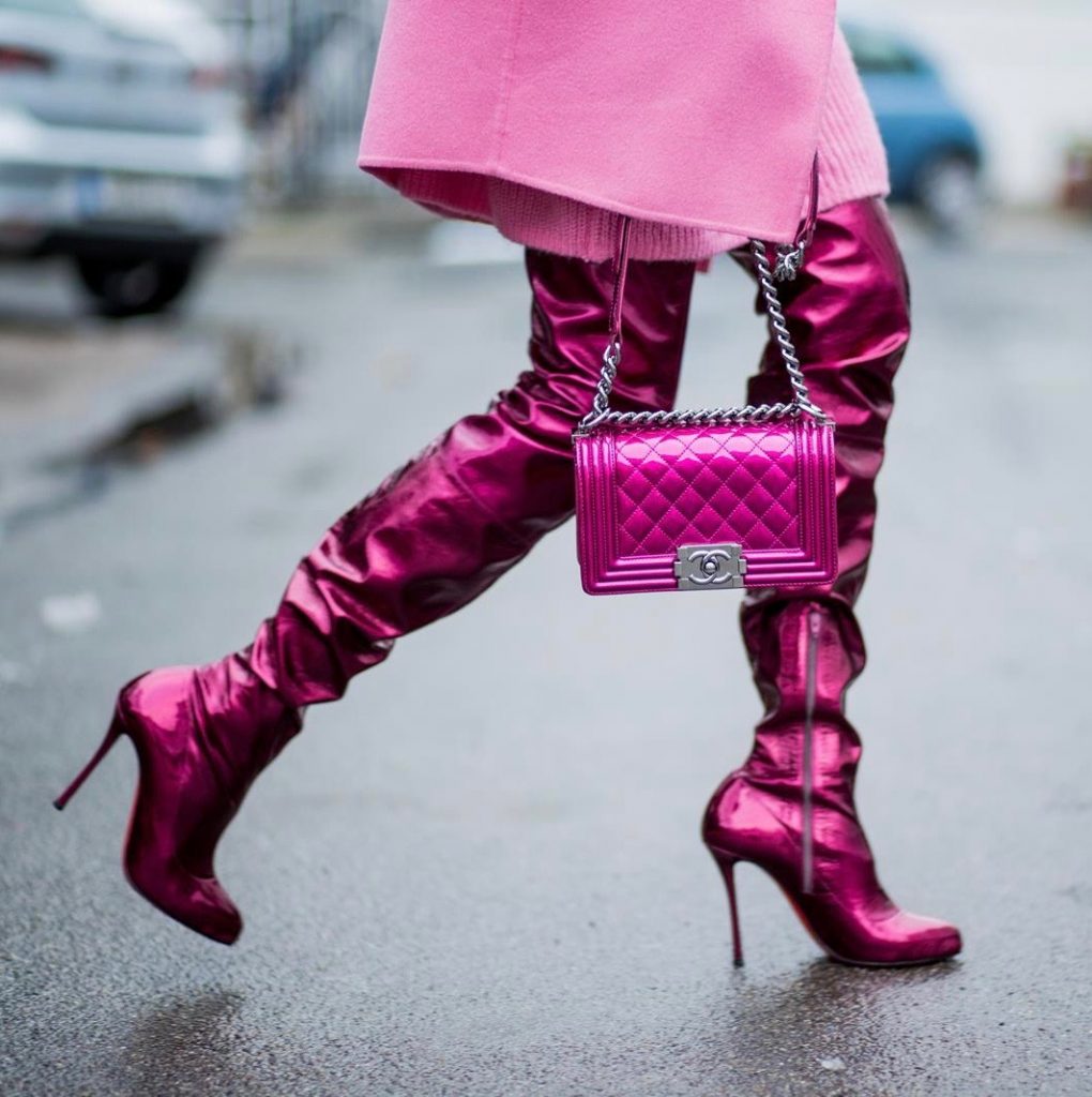 On Wednesdays we wear pink, Alexandra Lapp wearing overknee boots in metallic pink from Christian Louboutin, metallic pink Boy bag from Chanel, pink sunglasses from Le Specs, light pink knit dress from H&M and light pink cashmere coat from Prada on December 10, 2017 in Duesseldorf, Germany.