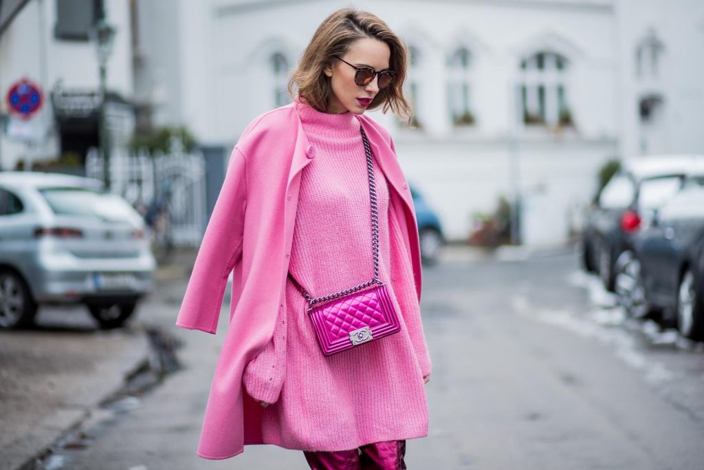 On Wednesdays we wear pink, Alexandra Lapp wearing overknee boots in metallic pink from Christian Louboutin, metallic pink Boy bag from Chanel, pink sunglasses from Le Specs, light pink knit dress from H&M and light pink cashmere coat from Prada on December 10, 2017 in Duesseldorf, Germany.