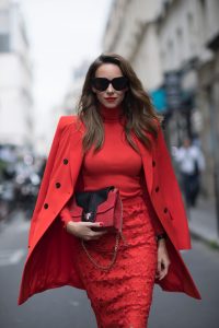 Alexandra Lapp seen wearing an orange outfit from Marc Cain, Manolo Blahnik heels in black with orange and Céline Audrey sunglasses, in the streets of Paris on September 27, 2017 in Paris, France.