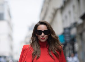 Alexandra Lapp seen wearing an orange outfit from Marc Cain, Manolo Blahnik heels in black with orange and Céline Audrey sunglasses, in the streets of Paris on September 27, 2017 in Paris, France.