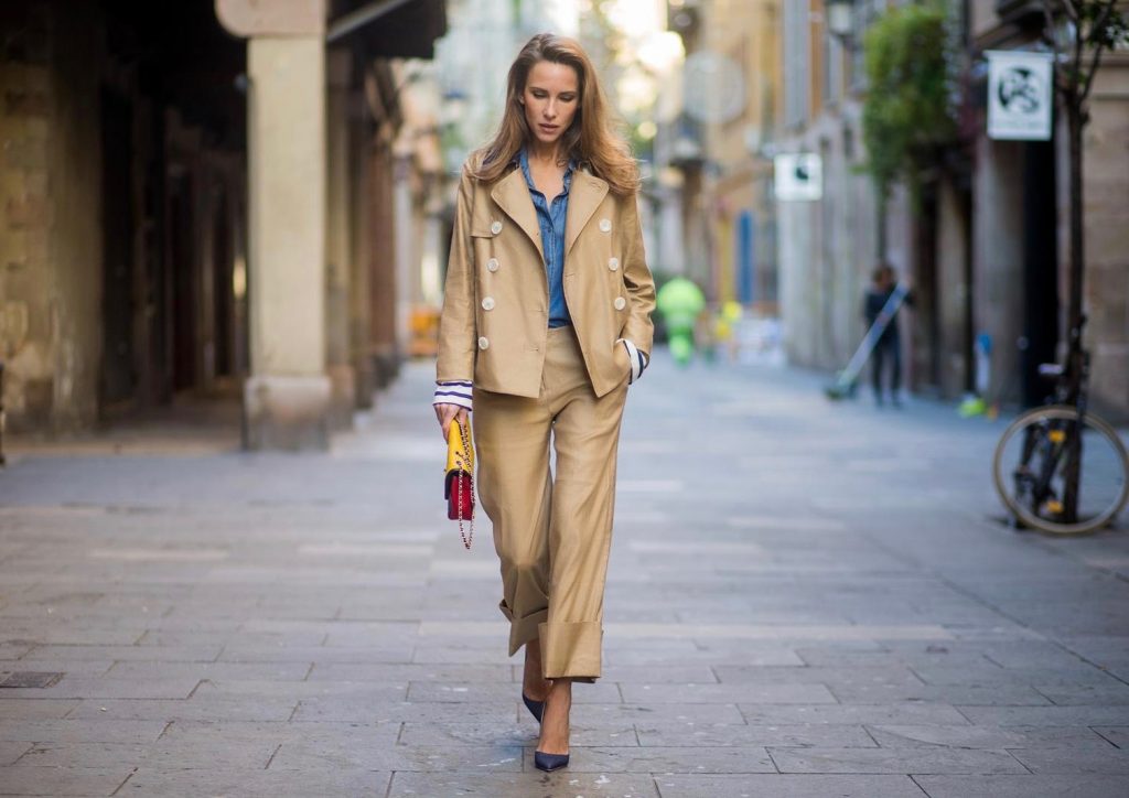 BARCELONA, SPAIN - NOVEMBER 27: Alexandra Lapp wearing Safari look, wide cut khaki pants from Steffen Schraut, khaki jacket with blue collar and blue and white strips on the bottom of the sleeve from Steffen Schraut, denim shirt by Steffen Schraut, So Kate Pumps from Christian Louboutin in denim, Chanel 2.55 bag in red, blue and yellow with golden logo buckle on November 27, 2017 in Barcelona, Spain.